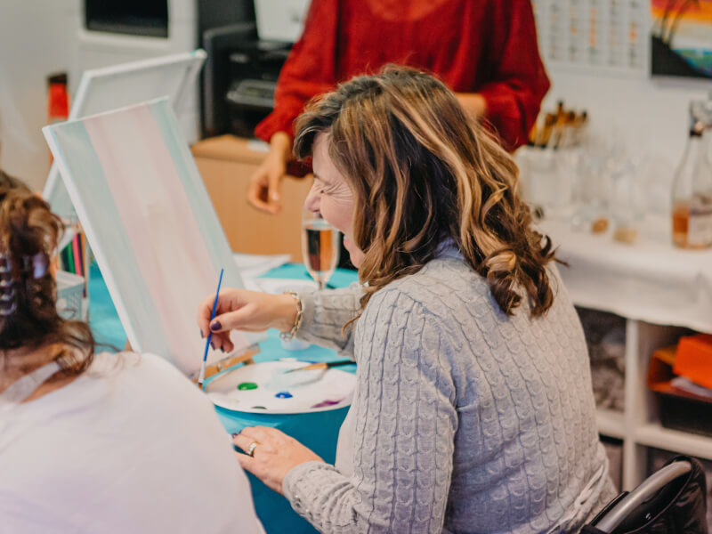 Woman enjoying her painting class